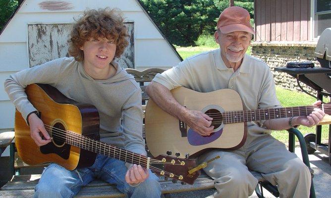 taylorandgrandpa.jpg - My Grand/Son Taylor Clark, left, plays the guitar very well.